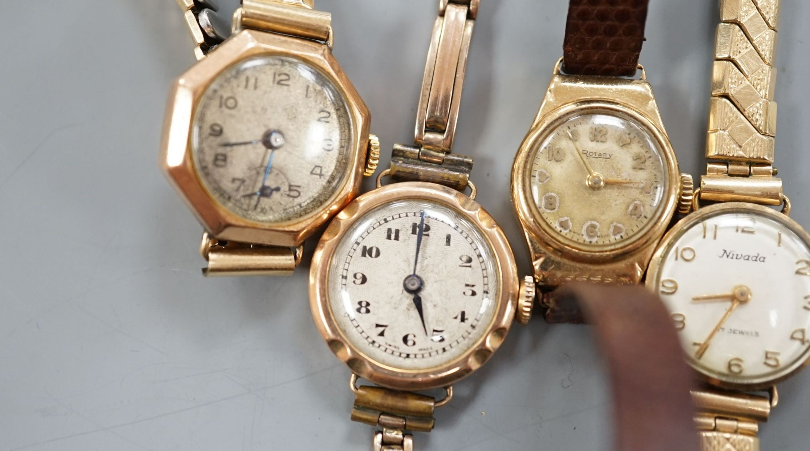 Three lady's early to mid 20th century 9ct gold manual wind wrist watches, one on a 9ct bracelet and one other yellow metal wrist watch